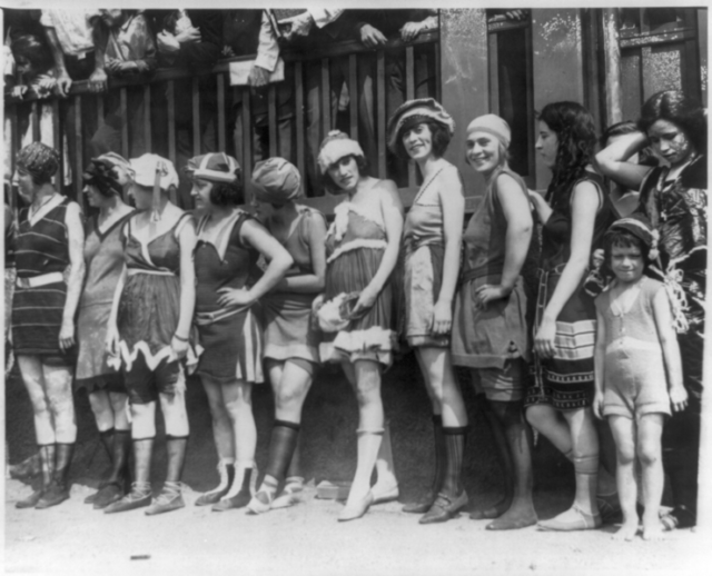 11 women and a little girl lined up for bathing beauty contest, USA