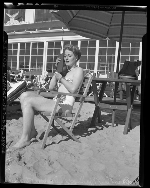 Dorothy McGrath lounging on a Los Angeles beach while using Walkie Talkie radio set, circa 1947 .source