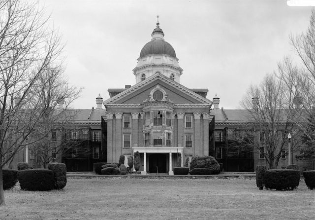 Taunton State Hospital was once a lovely example of the massive Kirkbride asylums. Photo of the Administration Building, 1987. Source