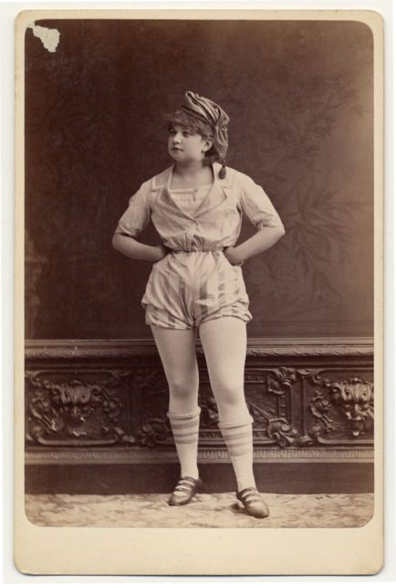 Unidentified female performer in a short sailor-style costume, shoes with knee-high stockings.