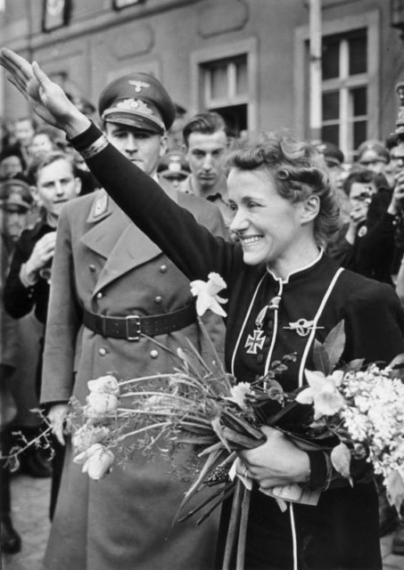 Captain Hanna Reitsch's reception in her hometown of Hirshberg in Silesia. She is shown thanking the people for her reception. Near her is the Gauleiter of Lower Silesia, Senior-President Hanke. Source