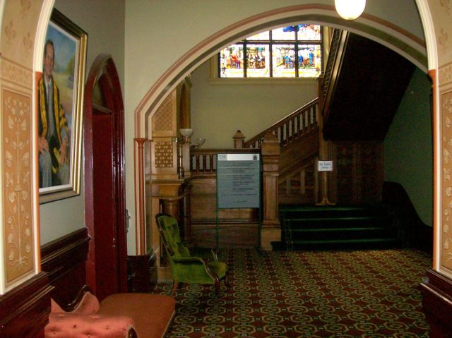 Main staircase with part of Gordon Window visible. Source