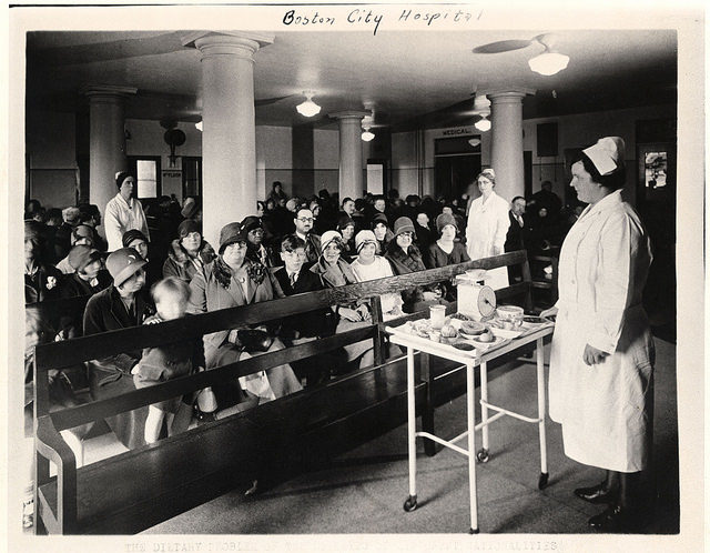 Outpatient clinic with nurses and patients, 1920