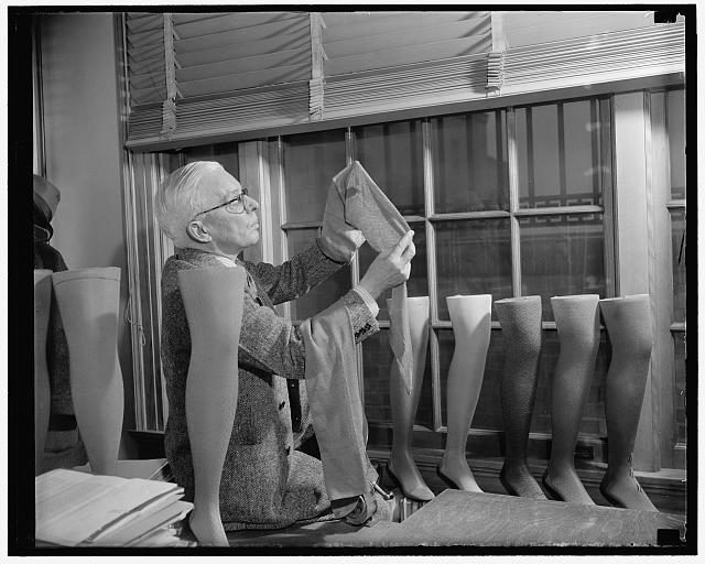 A technician inspects a pair of nylon stockings. Source: Library of Congress / Public Domain