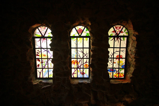 Glass flowers at the windows of the castle. Source