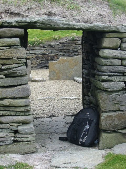 Looking back through the low entrance doorway into the main house, a visitor's backpack gives an idea of scale. CC BY-SA 3.0, https://commons.wikimedia.org/w/index.php?curid=250072