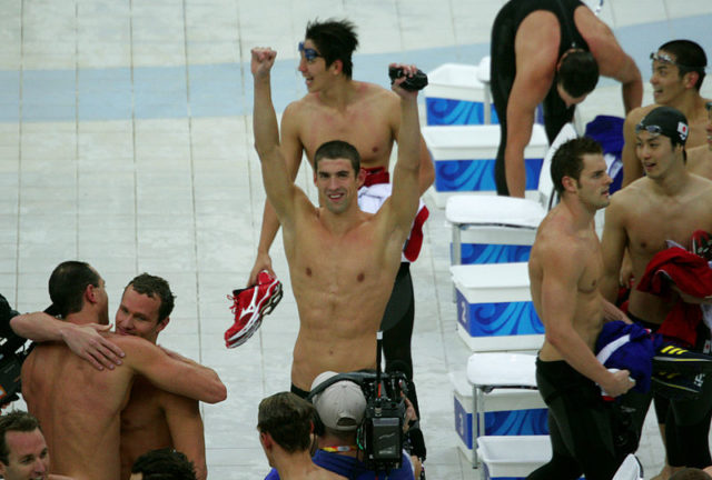 Michael Phelps celebrates with his teammates after winning his 8th gold medal.