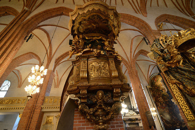 The monumental pulpit is the work of Burchard Precht in 1698-1702 and is in a French Baroque style and became the model for a number of other large pulpits in Sweden. Source