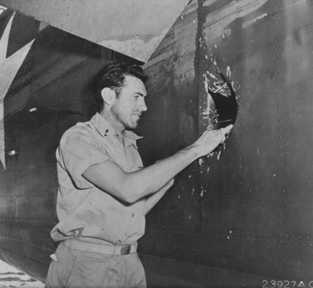 Zamperini examines a hole in his B-24D Liberator Super Man made by a 20mm shell over Nauru.