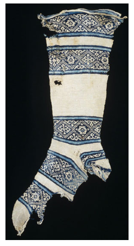 12th-century cotton sock, found in Egypt. The knitter of this sock started work at the toe and then worked up towards the leg. The heel was made last and then attached to loops formed while knitting the leg. This practice allowed the heel to be easily replaced when it wore out. Photo Credit