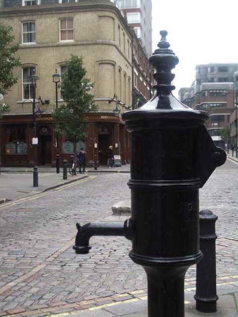 Broadwick Street showing the John Snow memorial and public house. Note: The memorial pump was removed due to new construction (March 2016). A plaque affixed to the public house reads, "The Red Granite kerbstone mark is the site of the historic BROAD STREET PUMP associated with Dr. John Snow's discovery in 1854 that cholera is conveyed by water."