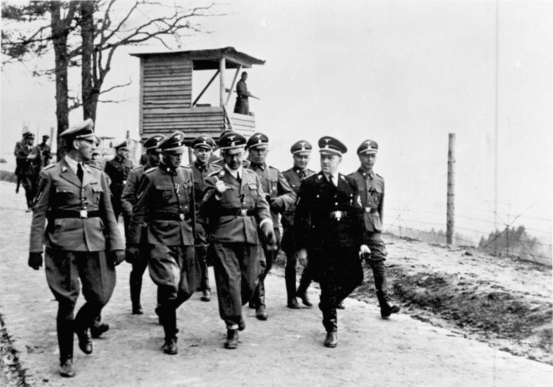 Kaltenbrunner (on the far left), Heinrich Himmler and August Eigruber inspect Mauthausen concentration camp in 1941, in the company of camp commander Franz Ziereis. Source: By Bundesarchiv, Bild 183-45534-0005 / CC-BY-SA 3.0, 