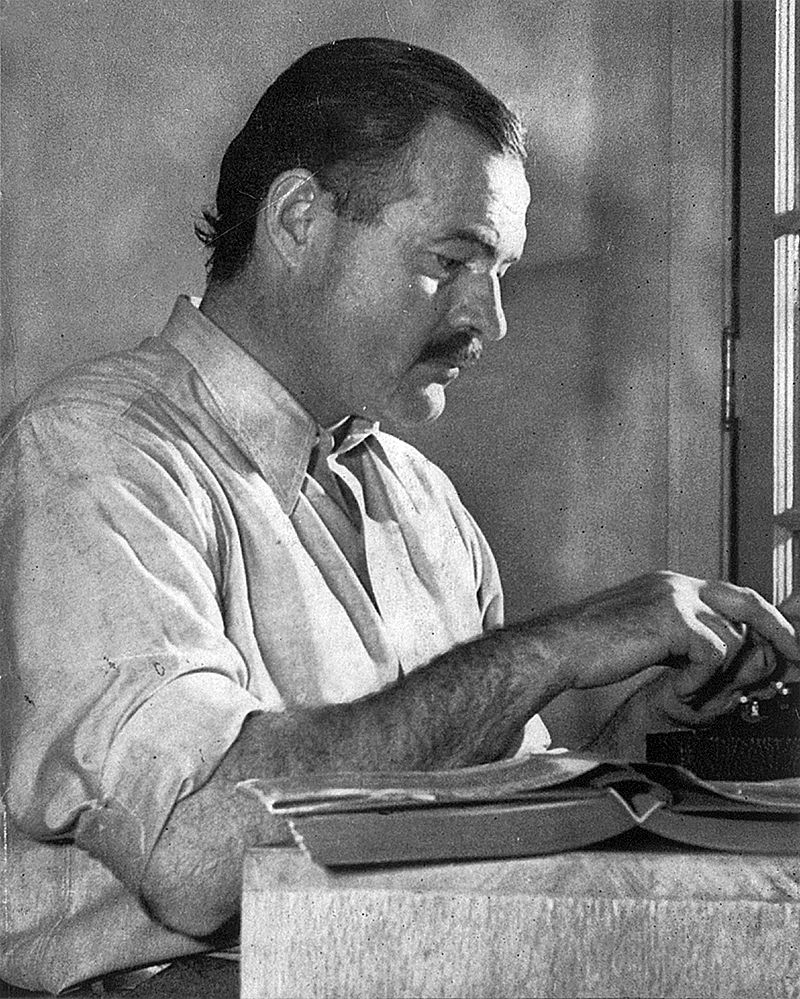 Hemingway posing for a dust jacket photo by Lloyd Arnold for the first edition of "For Whom the Bell Tolls", at the Sun Valley Lodge, Idaho, late 1939.