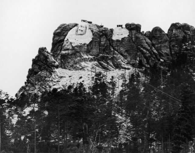 Mount Rushmore rising above the trees