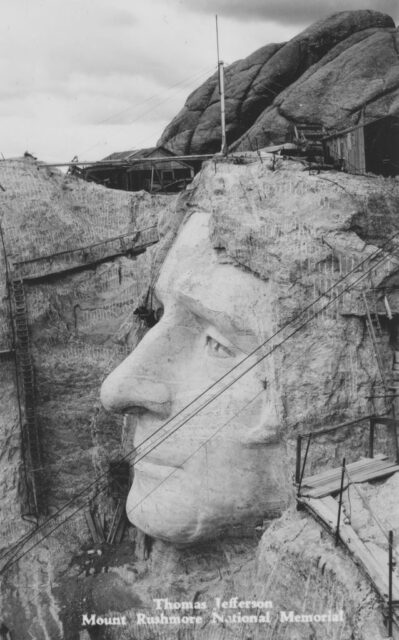 Construction equipment around the head of Thomas Jefferson in Mount Rushmore