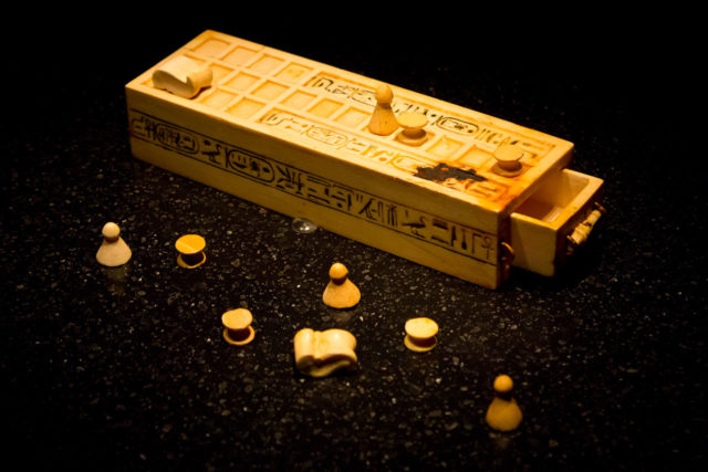 A game box and pieces for playing the game of Senet found within the intact KV62 tomb of king Tutankhamun. This object is today part of the permanent collection of the Cairo Museum of Egypt. This photo was taken at the King Tut exhibition at the Pacific Science Center in Seattle, Washington State, USA. By ddenisen (D. Denisenkov) - http://www.flickr.com/photos/ddenisen/7364442692/in/photostream/, CC BY-SA 2.0, https://commons.wikimedia.org/w/index.php?curid=24852343