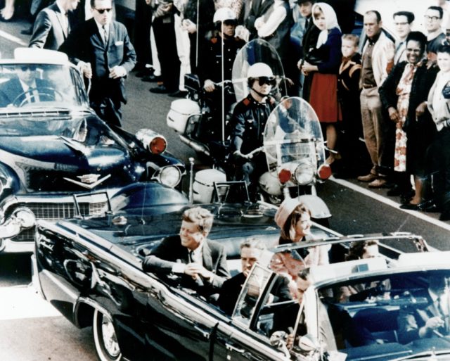 Picture of President Kennedy in the limousine in Dallas, Texas, on Main Street, minutes before the assassination. Also in the presidential limousine are Jackie Kennedy, Texas Governor John Connally, and his wife, Nellie.