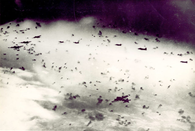 The 303rd BG’s B-17s fly through heavy flak. Photo Credit