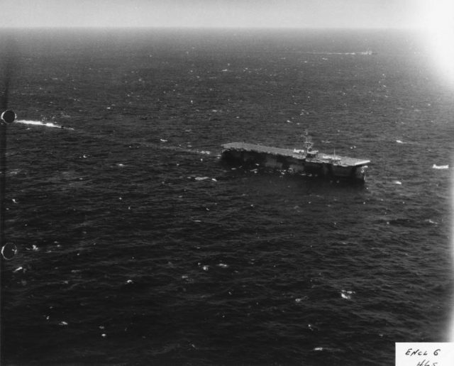 Aerial view off starboard bow of the carrier with the sub in tow.
