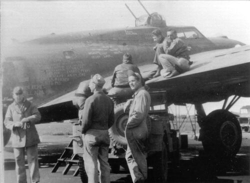 “SQUAWKIN’ HAWK” poses with the Armament section of the 349th 