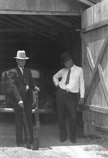 B.M. “Maney” Gault and Frank Hamer examine some of Clyde’s boom sticks. 