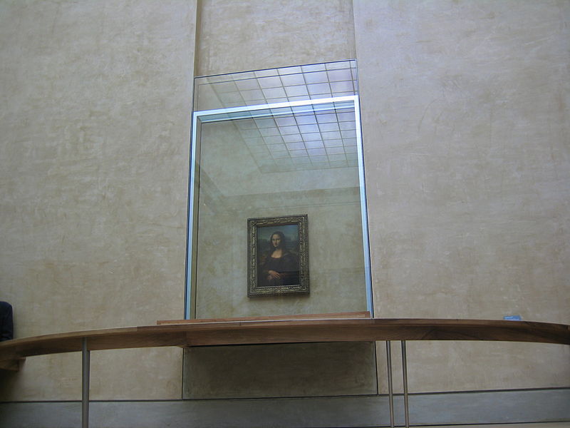 Mona Lisa behind bulletproof glass at the Louvre Museum. Photo Credit