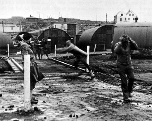 Building Quonset huts in a gale 1942. Photo Credit