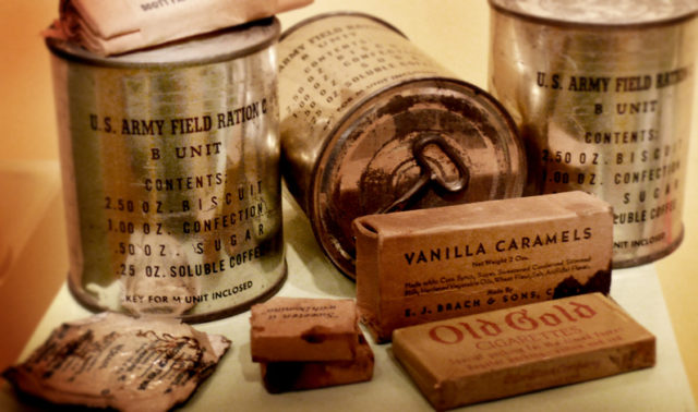 A selection of United States military C-ration cans from World War II with items displayed. Photo Credit