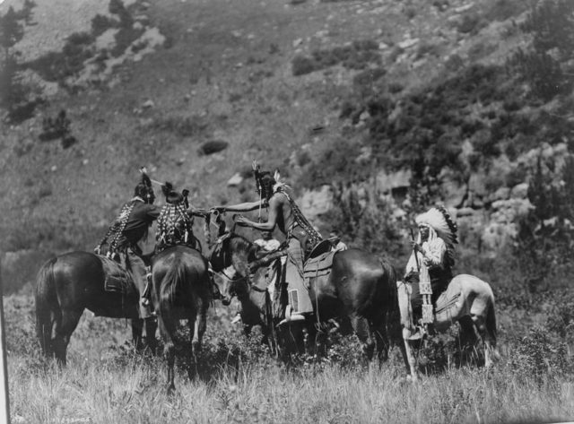 Crow men trading on horseback- Edward S. Curtis