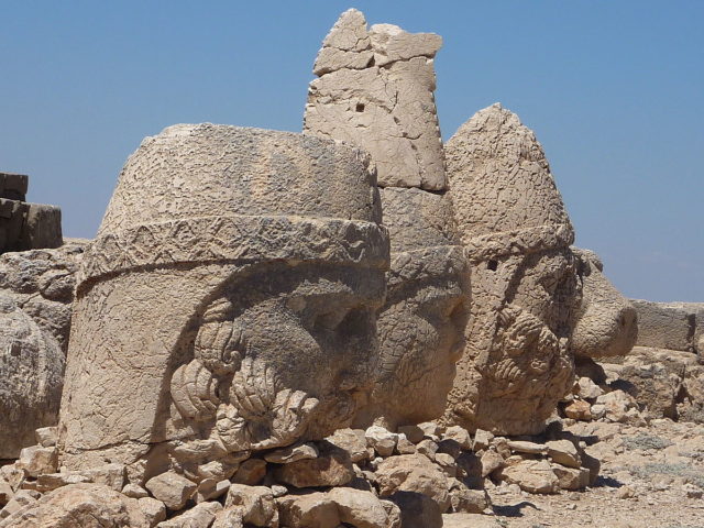 Heads of statues at the top of the mountain. Photo Credit