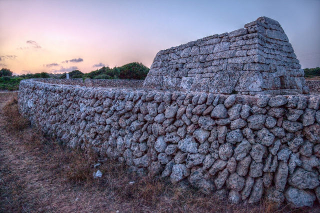 It stands on slightly rising ground in a sloping valley. Photo Credit