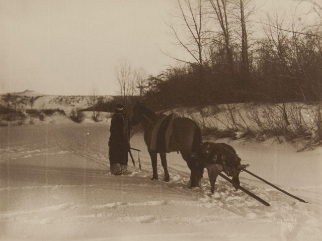 Native american-with horse pulling travois 1910