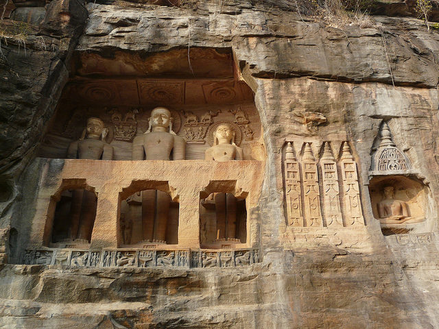 The southern path of the fort is bounded by rock faces with intricate carvings of the Jain tirthankars. Photo Credit,,