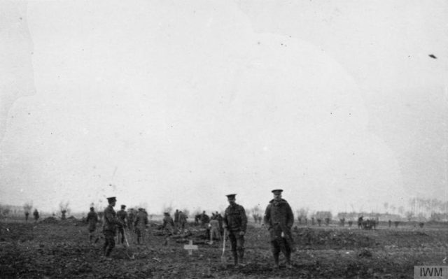 British and German troops burying the bodies of those killed in the battle of December 18, 1914.