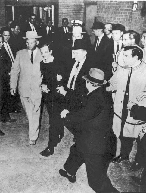 Jack Ruby, just a split-second before firing a single shot into Oswald, who is being escorted by police detectives Jim Leavelle (tan suit) and L.C. Graves for the transfer from the City Jail to the Dallas County Jail.