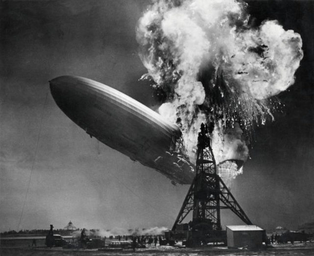 The stern of the Hindenburg begins to fall, with the mooring mast in the foreground.