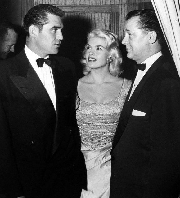 Photo of actor Steve Cochran, actress Jayne Mansfield and Ed Wynne, the owner of the Harwyn Club in New York, where the photo was taken Photo Credit