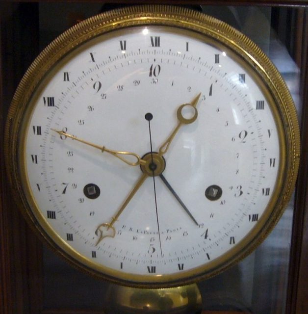 French decimal clock from the time of the French Revolution. The inner circle shows the ten hours of the decimal day in Arabic numerals, while the outer circle shows the two 12-hour periods of the standard 24-hour day in Roman numerals. Photo credit