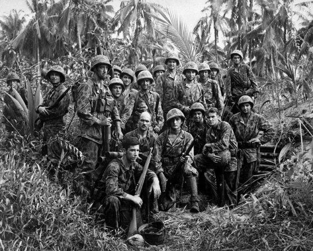 Marine Raiders gathered in front of a Japanese dugout on Bougainville.