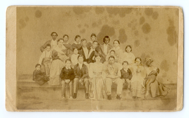 1860s family portrait of Chang & Eng with wives and 18 of 22 children and Grace Gates, one of the 33 slaves on their plantation.
