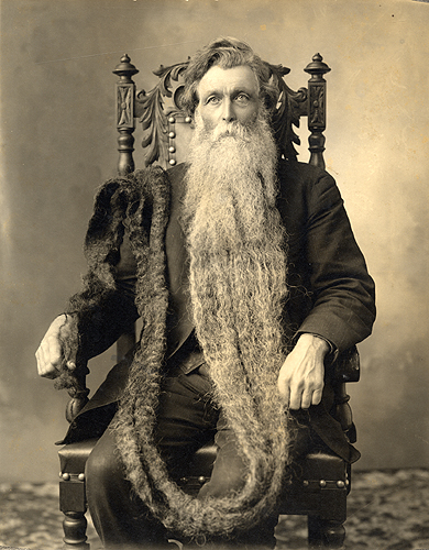 Hans Langseth (1846–1927) at age 66 seated in ornate chair with beard draped over his shoulder and down to his hand.