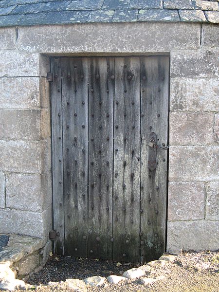 It still has the original stout oak door and protective metal shutter and keyhole. Photo Credit