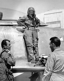 Cochran standing on the wing of her F-86 talking to Chuck Yeager and Canadair's chief test pilot Bill Longhurs