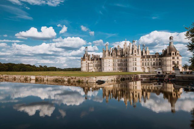 The château and decorative moat, viewed from the North-West (2015) Photo Credit