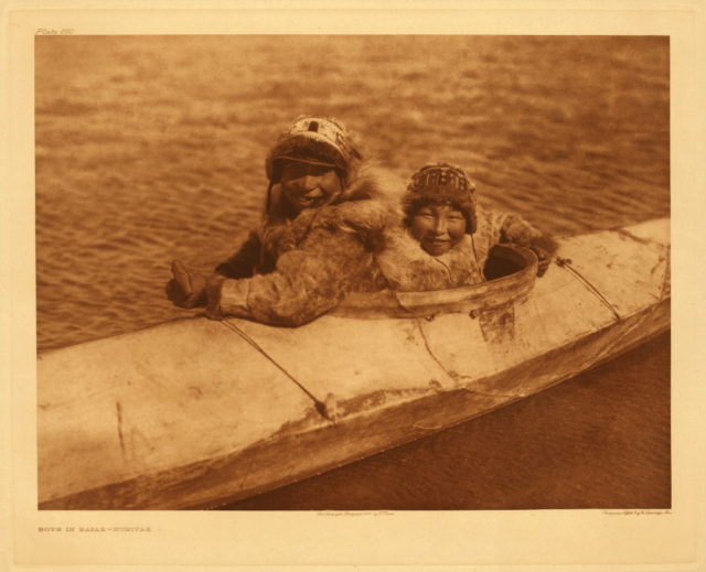 Two people in kayak, Nunivak, Alaska, photographed by Edward S. Curtis, 1930. Boys in kayak, Nunivak, 1930 Photo Credit