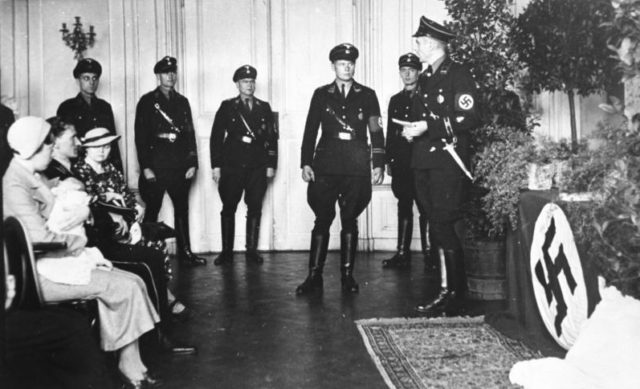 Photo showing a child's baptism (christening) ceremony ritual; conducted by members of the SS at a Lebensborn e.V. maternity care home in Rheinhessen somewhere between 1936-1944.Photo Credit