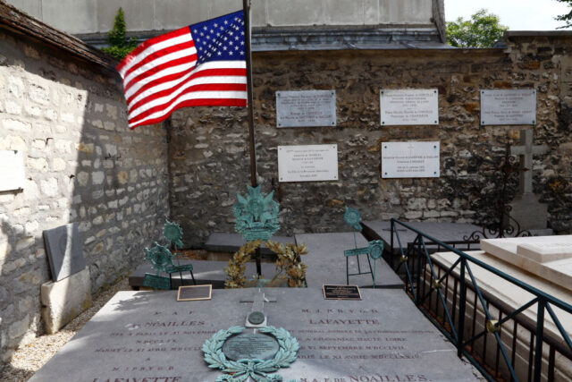 American flag flying over the Marquis de Lafayette's gravestone