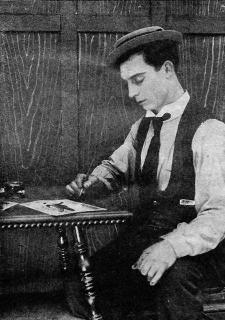 Actor Buster Keaton autographing photographs, on page 48 of the January 1921 Film Fun.