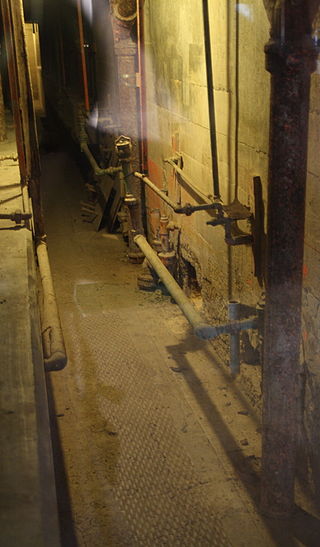 Unguarded utility corridor behind the escapees’ cells. Photo Credit