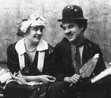 Chaplin and Edna Purviance, his regular leading lady, in Work (1915).